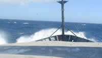 Waves crash over bow